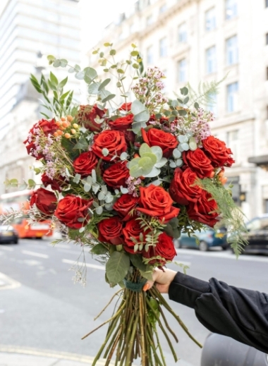 wild red roses arranged in a heart shaped bouquet with eucalypthus, pussy willow and matching foliages. Made by Blooms and Candy LOndon florist for guaranteed London delivery